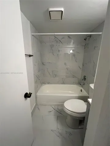 a kitchen with a refrigerator a stove and cabinets