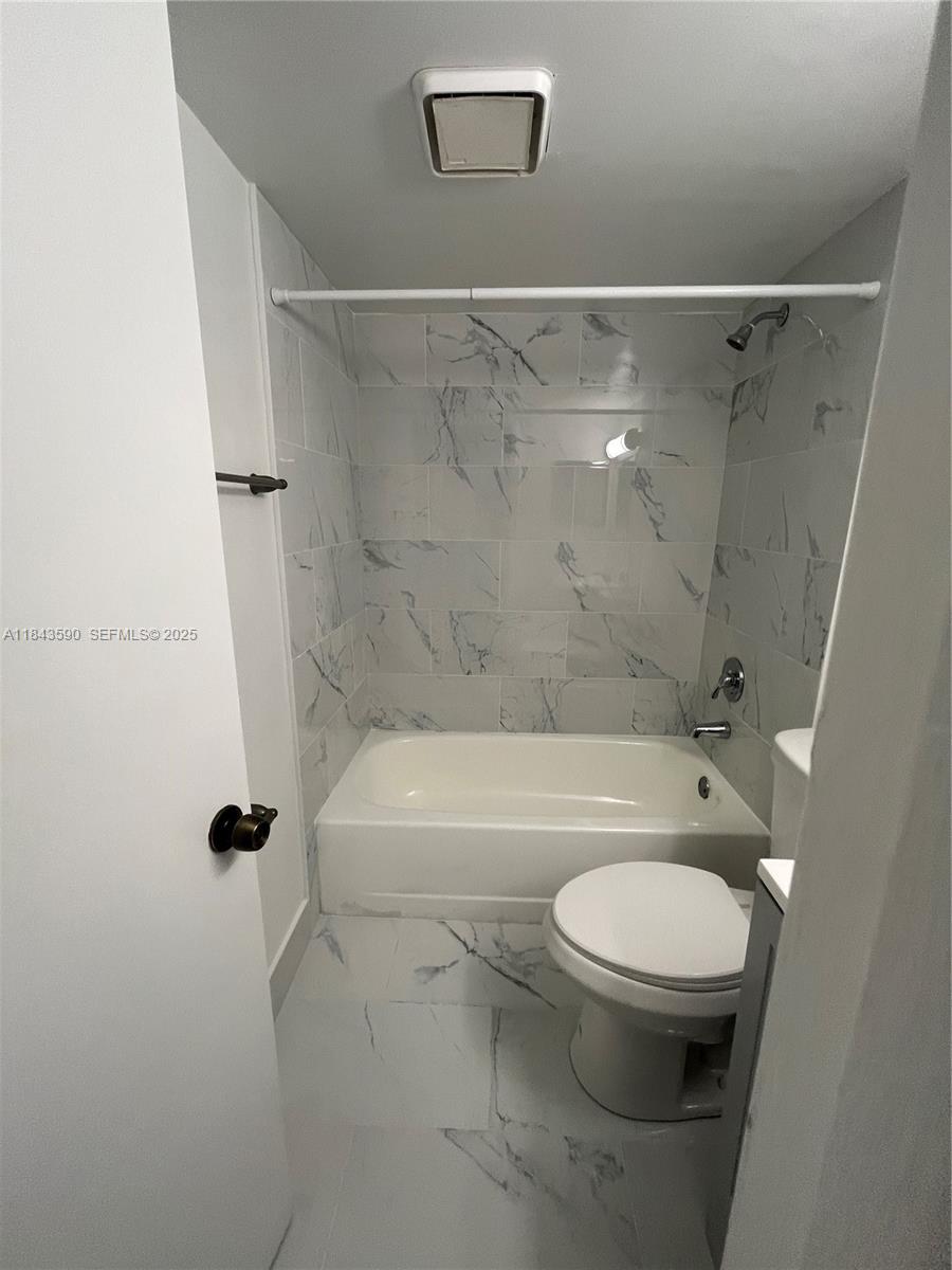 7430 Southwest 153rd Place, Unit 1061 Miami, FL 33193 - Photo 21 of 42 a white toilet sitting next to a bath tub and a shower