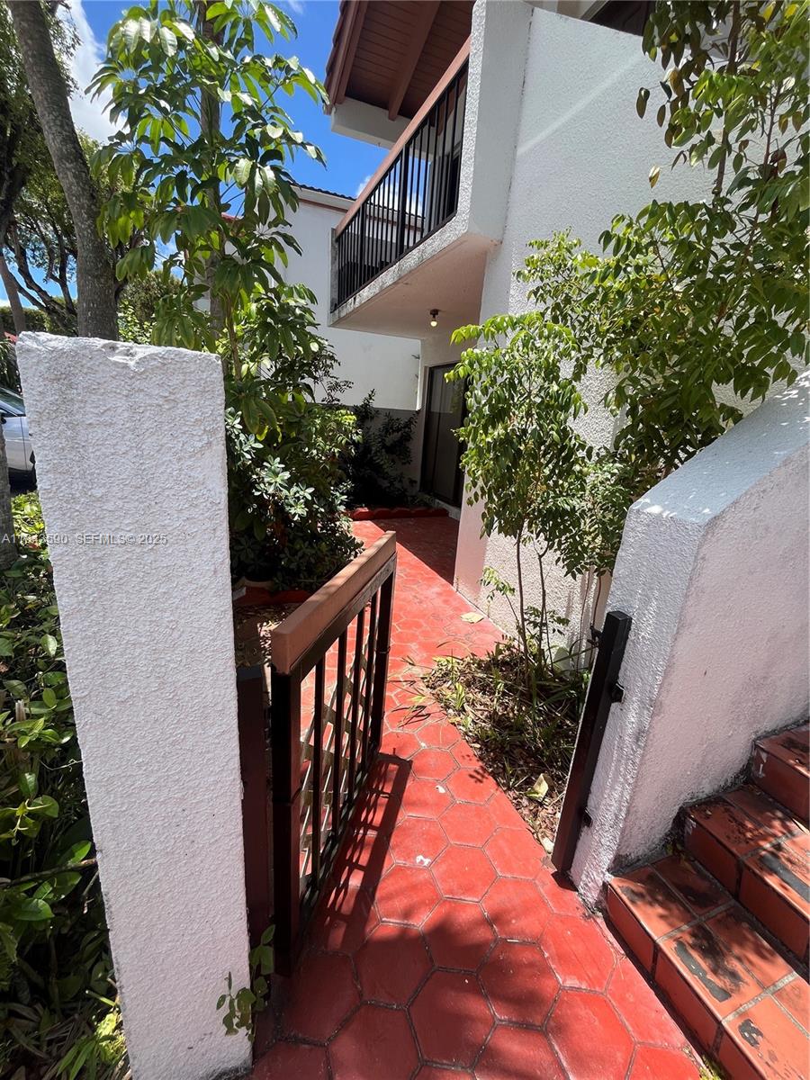 7430 Southwest 153rd Place, Unit 1061 Miami, FL 33193 - Photo 23 of 42 a view of a patio with chair and potted plants