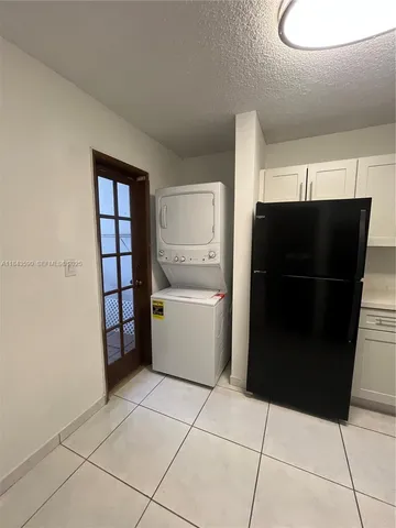 a kitchen with a stove top oven and cabinets