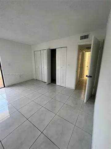 a kitchen with white cabinets and black appliances