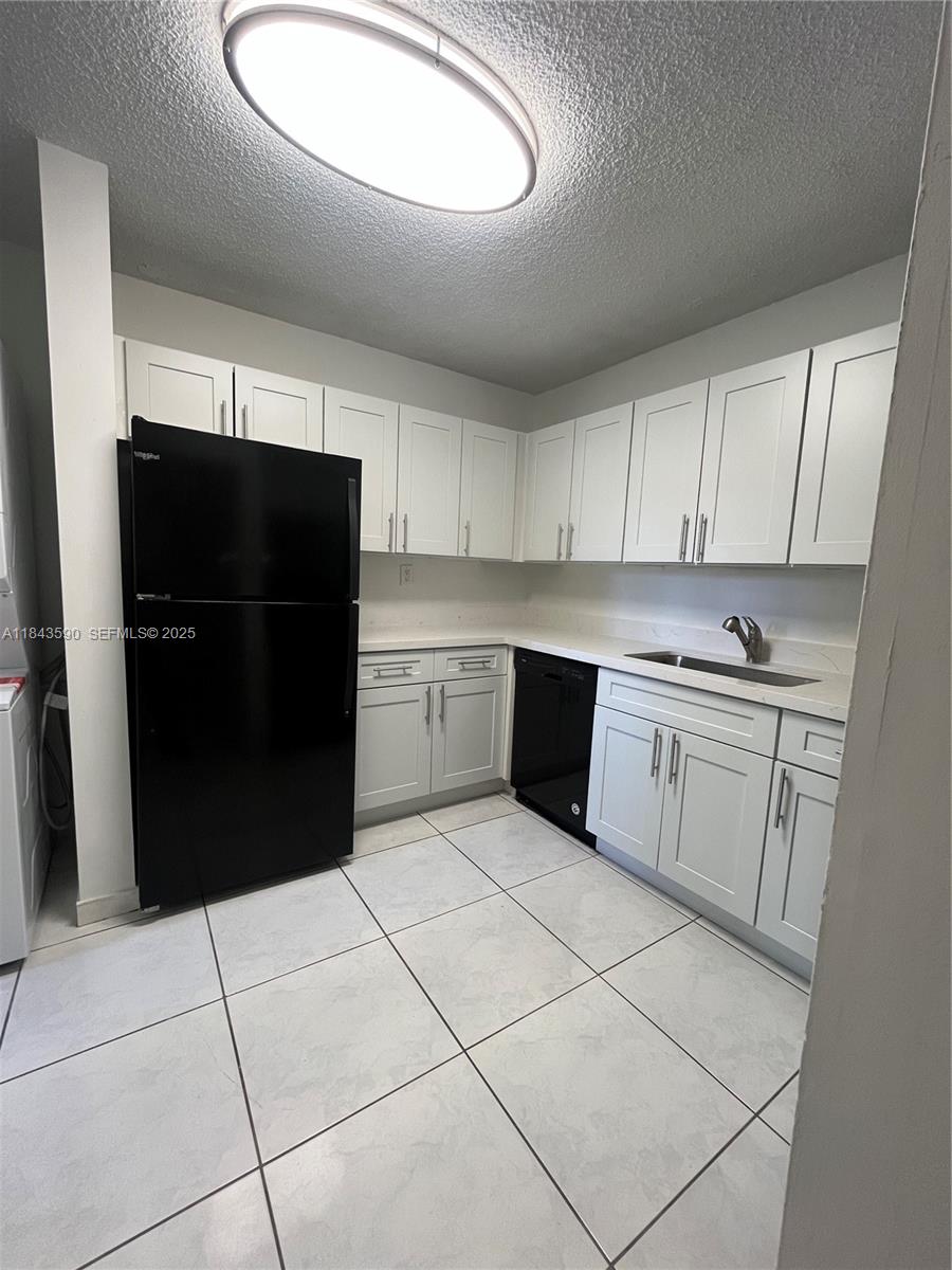 7430 Southwest 153rd Place, Unit 1061 Miami, FL 33193 - Photo 33 of 42 a kitchen with stainless steel appliances granite countertop a refrigerator sink and cabinets