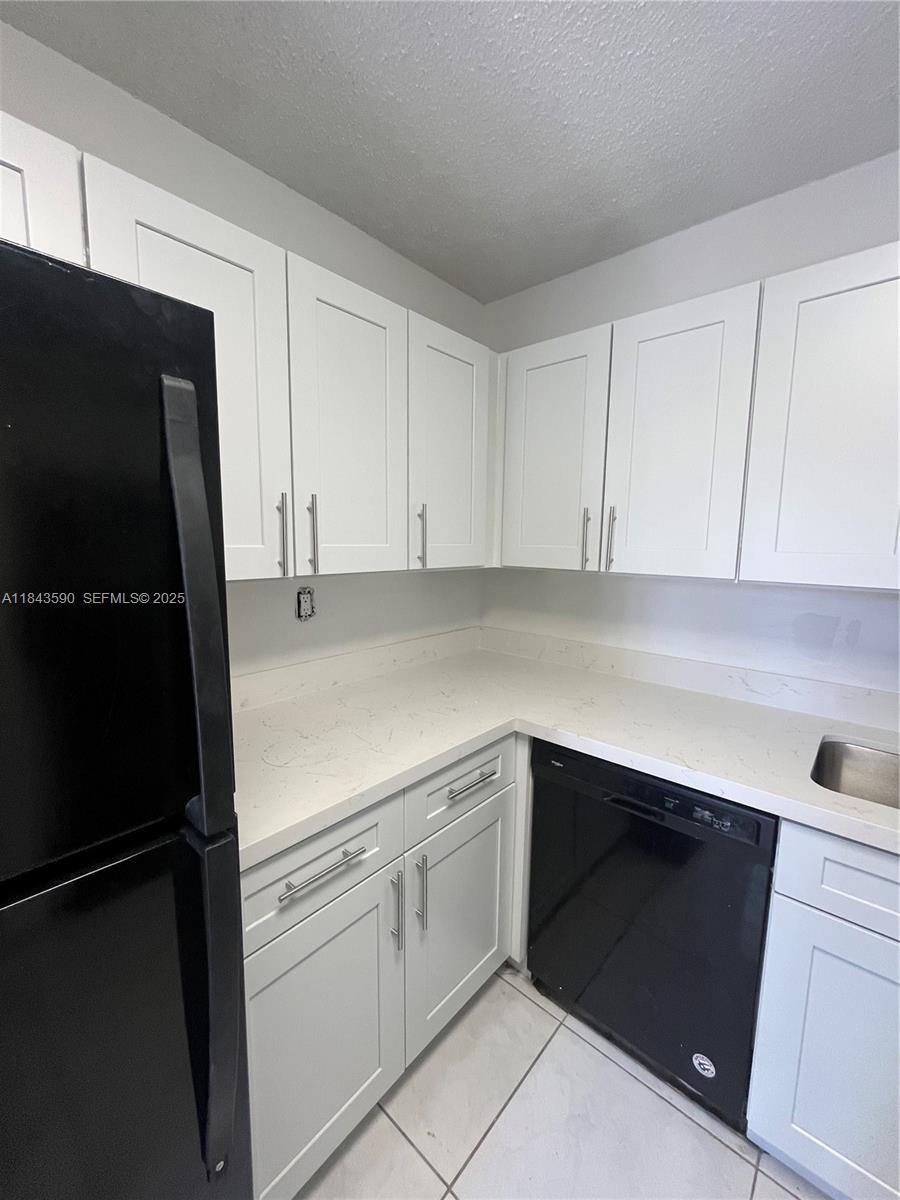 7430 Southwest 153rd Place, Unit 1061 Miami, FL 33193 - Photo 40 of 42 a kitchen with a sink and a refrigerator