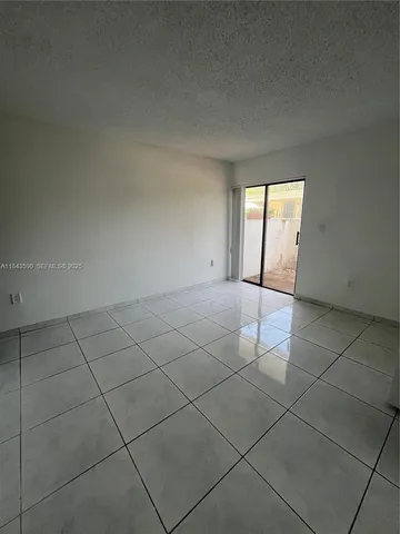 a view of a livingroom with an empty space and window