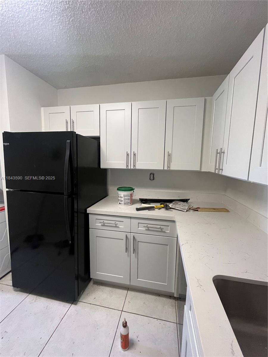 7430 Southwest 153rd Place, Unit 1061 Miami, FL 33193 - Photo 10 of 42 a kitchen with a refrigerator stove and cabinets