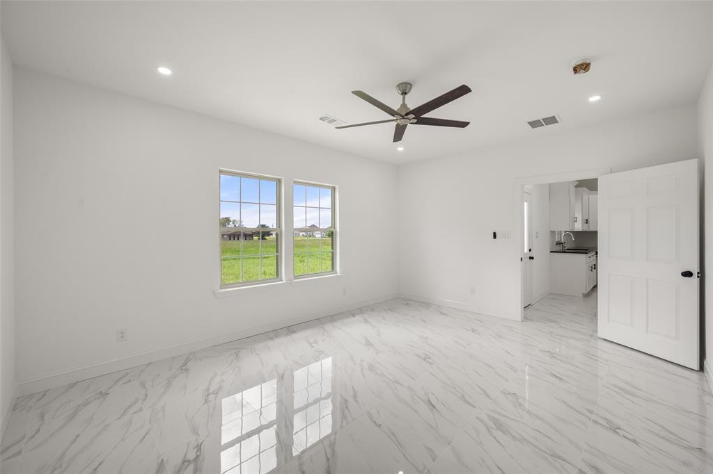 149 L B J Ranch Road Trinidad, TX 75163 - Photo 22 of 31 Spare room featuring a ceiling fan, light marble finish floors, and recessed lighting