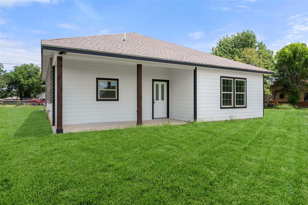 149 L B J Ranch Road Trinidad, TX 75163 - Photo 28 of 31 Rear view of property featuring roof with shingles and a yard