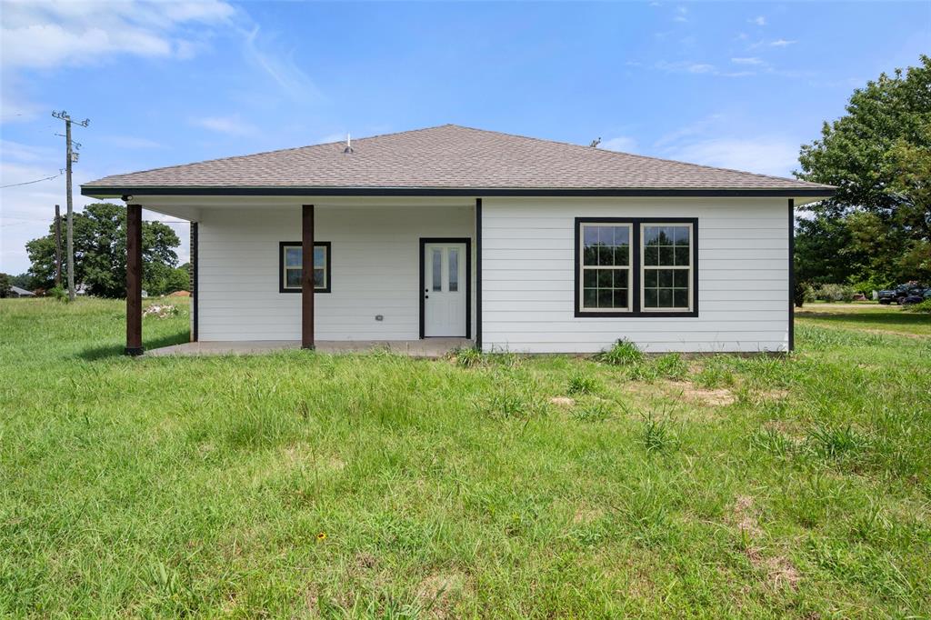 149 L B J Ranch Road Trinidad, TX 75163 - Photo 29 of 31 Back of property featuring roof with shingles
