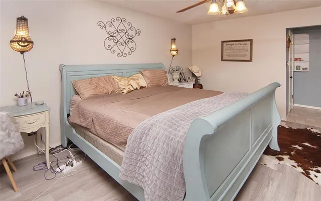 a bedroom with a bed and a chandelier