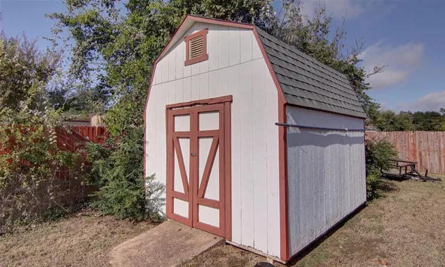 a building outdoor space with patio furniture and potted plants