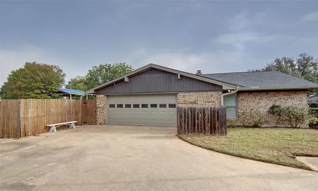 a view of a house with a yard and garage