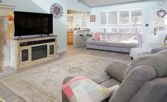 a view of a house with backyard and trees