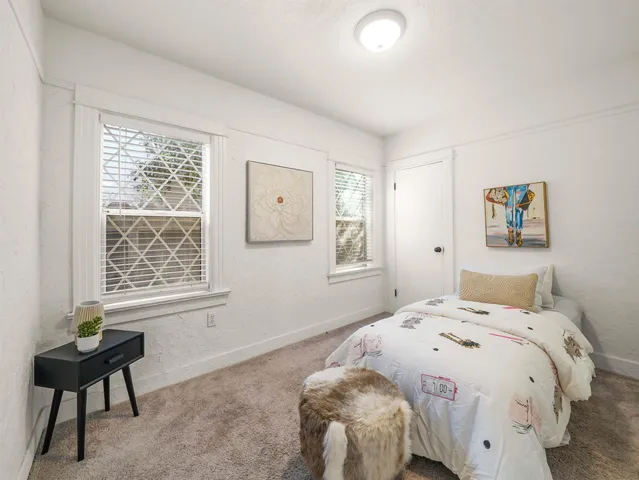 a bedroom with a bed and a window