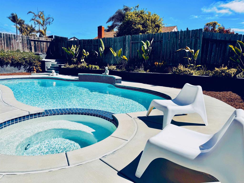 a view of swimming pool outdoor seating and outdoor kitchen