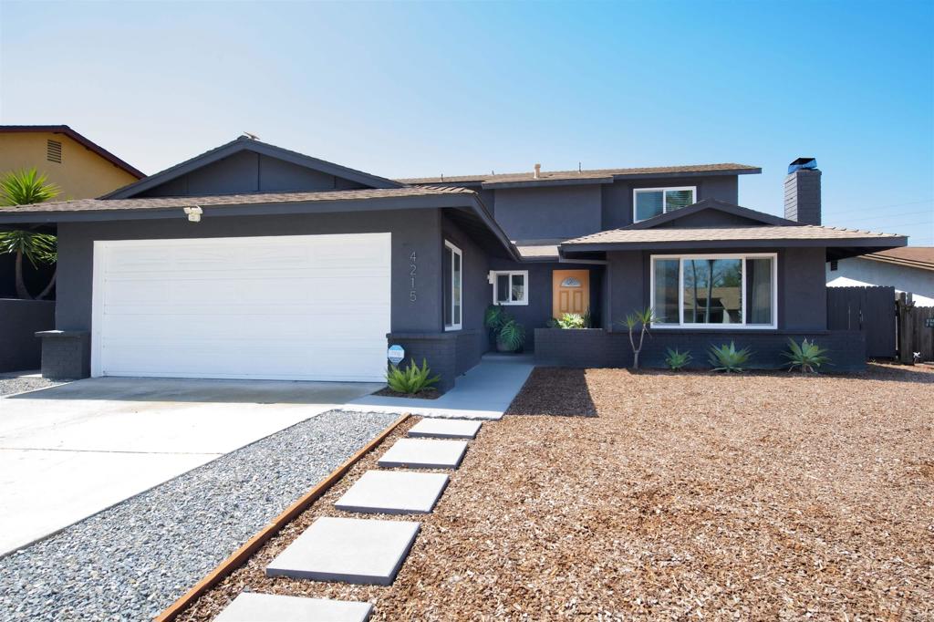 4215 Cielo Avenue Oceanside, CA 92056 - Photo 12 of 27 a front view of a house with a yard and garage
