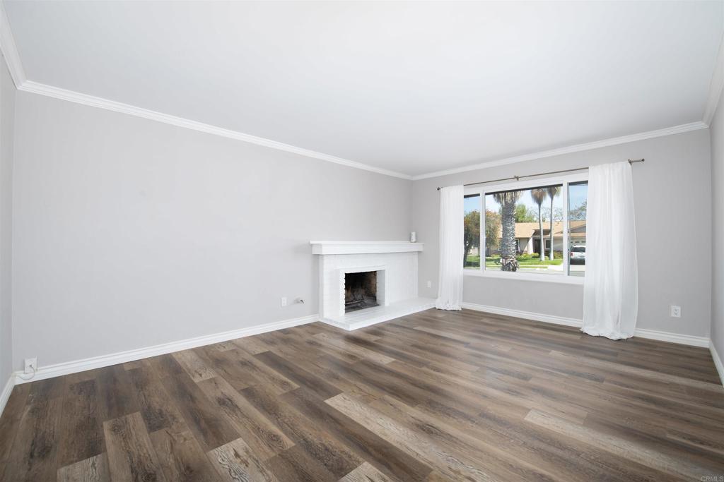 4215 Cielo Avenue Oceanside, CA 92056 - Photo 13 of 27 a view of an empty room with window and wooden floor
