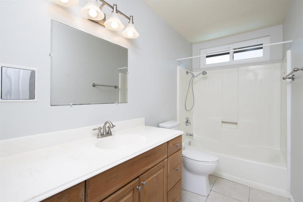 4215 Cielo Avenue Oceanside, CA 92056 - Photo 26 of 27 a bathroom with a sink a toilet and shower
