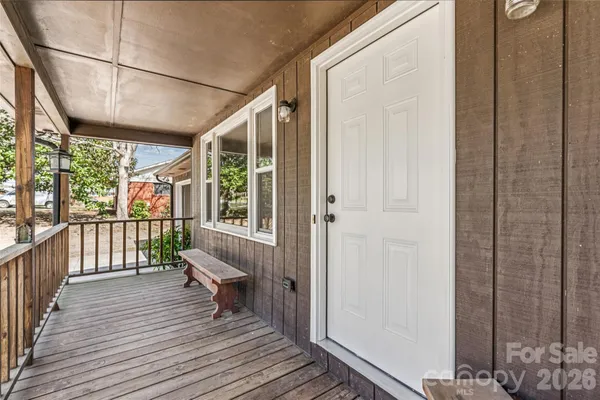 a view of a balcony with wooden floor