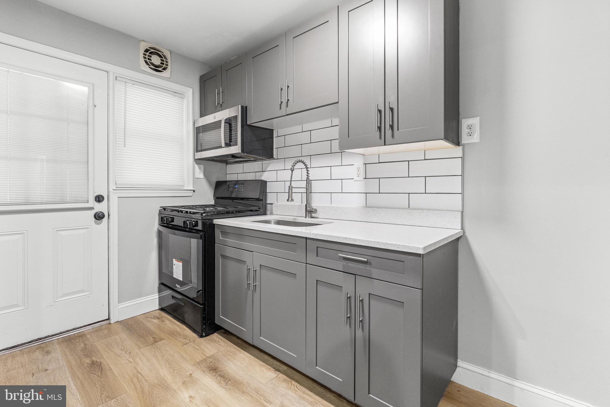 2203 Redthorn Road Baltimore, MD 21220 - Photo 8 of 23 a kitchen with stainless steel appliances granite countertop a sink stove and refrigerator