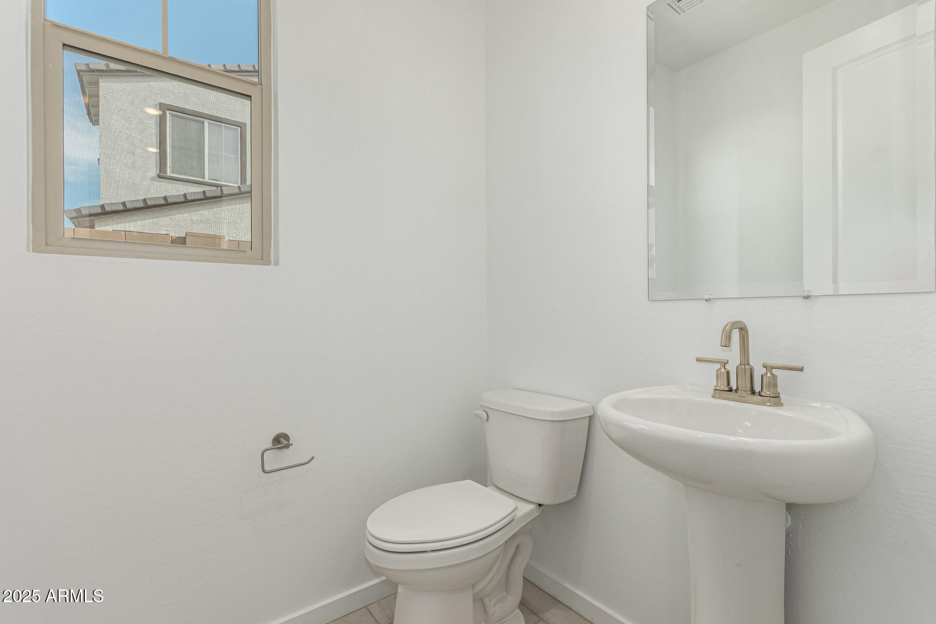 2474 West Rowel Road Phoenix, AZ 85085 - Photo 12 of 38 a bathroom with a toilet sink and mirror