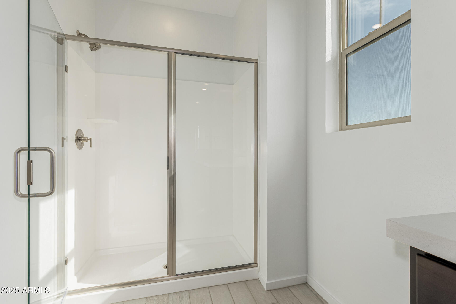 2474 West Rowel Road Phoenix, AZ 85085 - Photo 17 of 38 a bathroom with a glass shower door