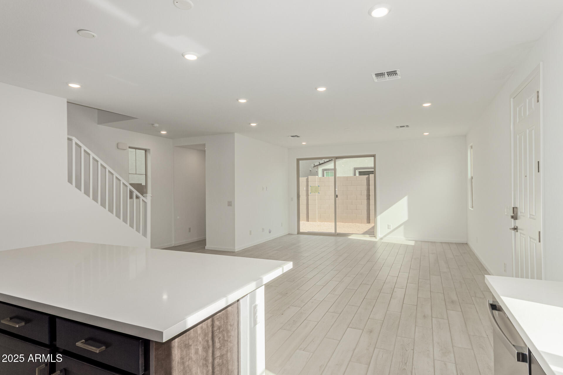 2474 West Rowel Road Phoenix, AZ 85085 - Photo 7 of 38 a view of an empty room with wooden floor