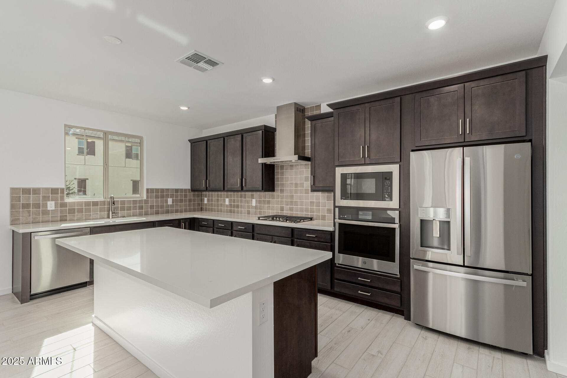 2474 West Rowel Road Phoenix, AZ 85085 - Photo 9 of 38 a kitchen with stainless steel appliances a refrigerator sink and microwave