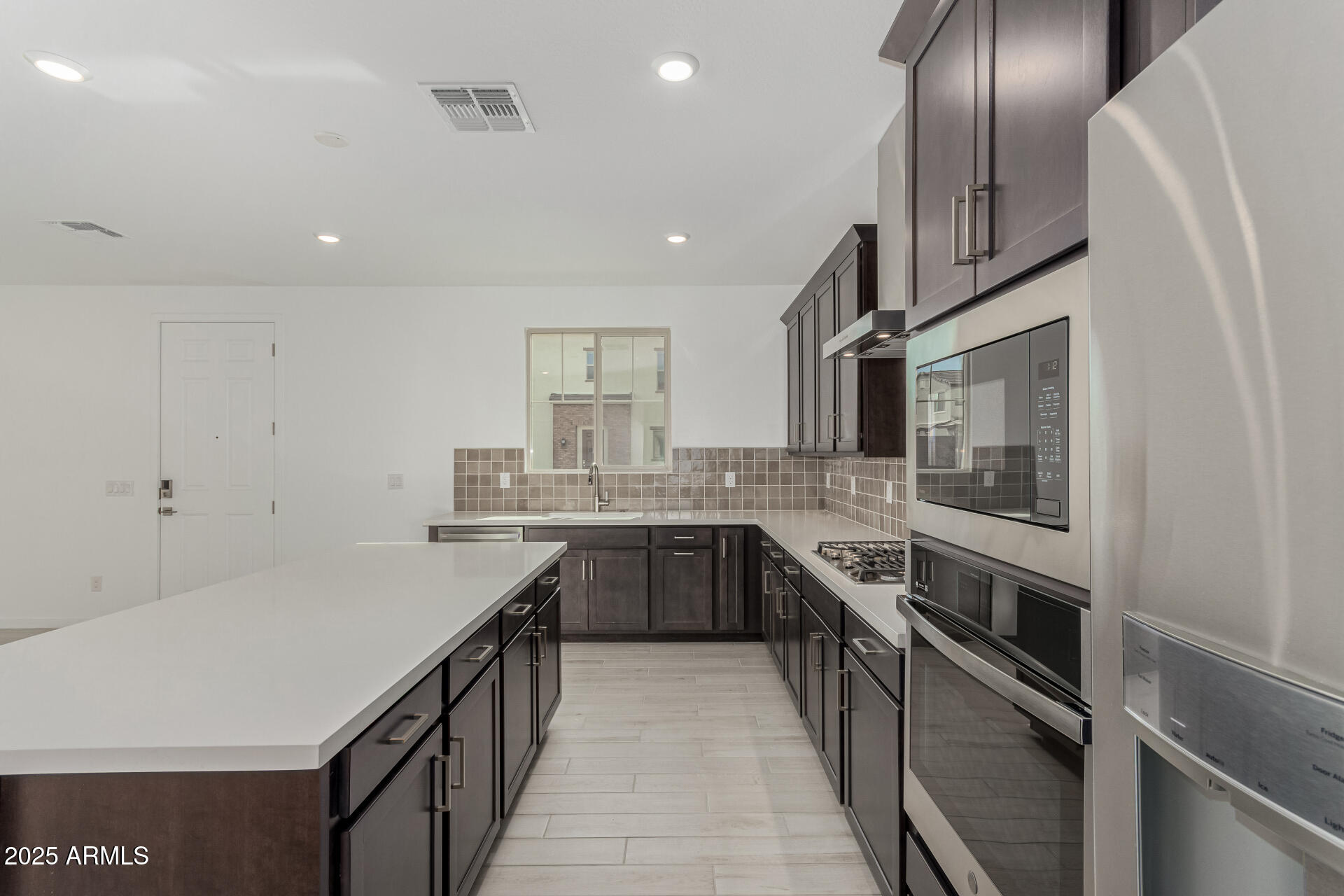 2474 West Rowel Road Phoenix, AZ 85085 - Photo 10 of 38 a kitchen with stainless steel appliances granite countertop a sink and stove top oven