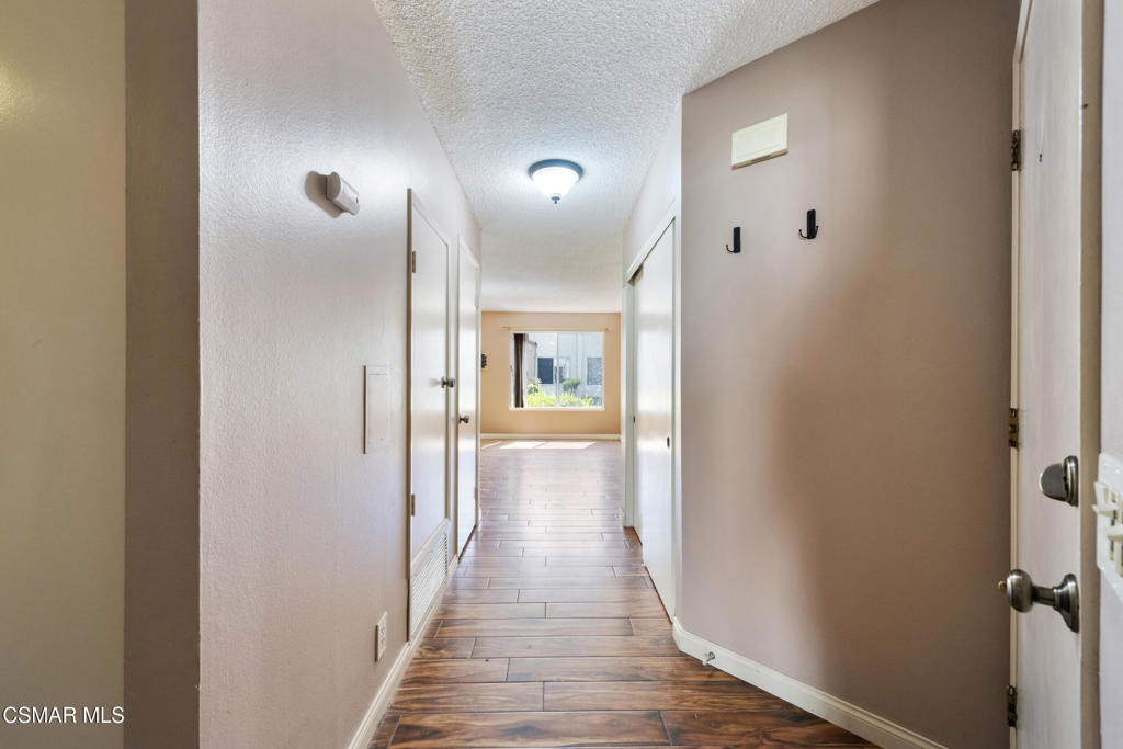 1772 Sinaloa Road, Unit 189 Simi Valley, CA 93065 - Photo 11 of 29 a view of a hallway with wooden floor and staircase