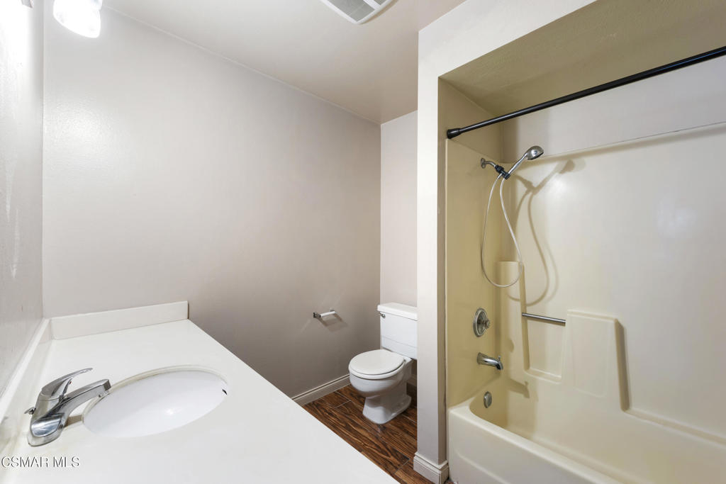 1772 Sinaloa Road, Unit 189 Simi Valley, CA 93065 - Photo 17 of 29 a bathroom with a granite countertop sink a toilet and a bathtub