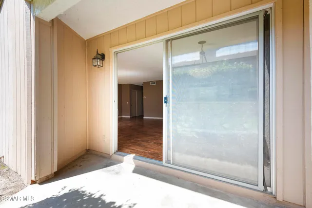 a view of a porch with furniture and a yard