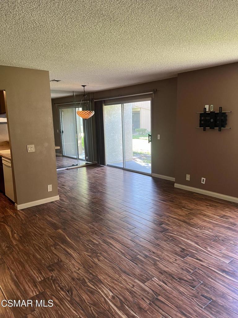 1772 Sinaloa Road, Unit 189 Simi Valley, CA 93065 - Photo 2 of 29 an empty room with wooden floor and windows