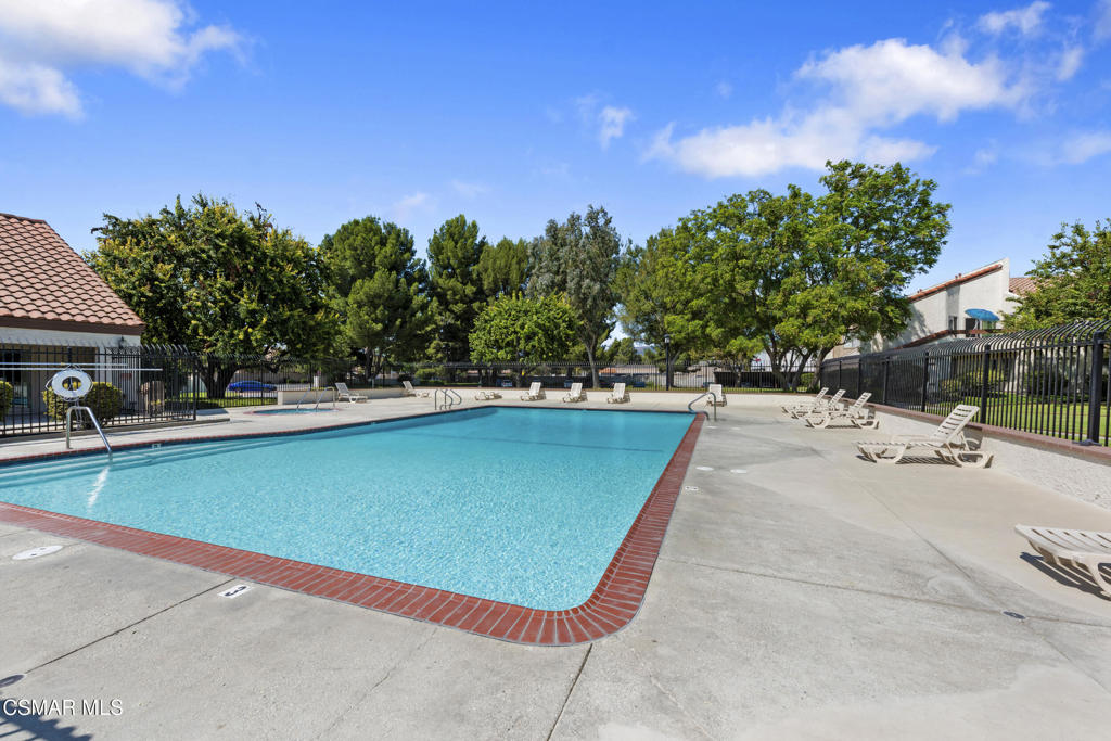 1772 Sinaloa Road, Unit 189 Simi Valley, CA 93065 - Photo 27 of 29 a view of a swimming pool with lawn chairs under an umbrella