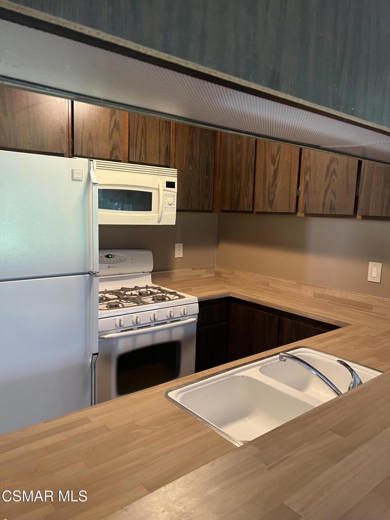 1772 Sinaloa Road, Unit 189 Simi Valley, CA 93065 - Photo 3 of 29 a kitchen with a stove and a microwave