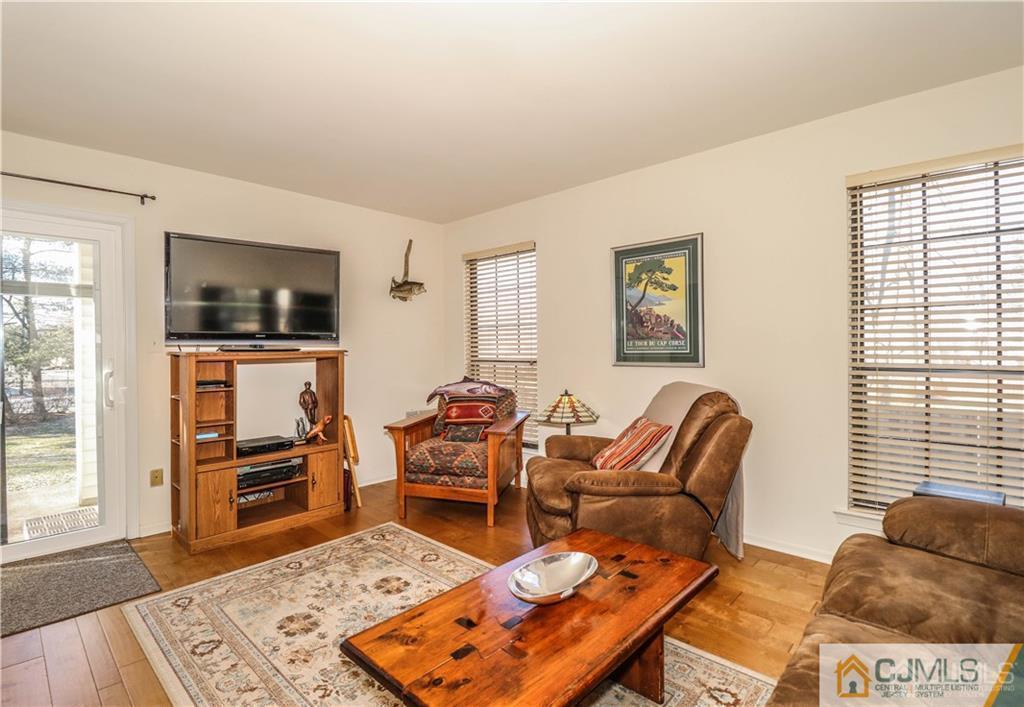 306 Maplecrest Road, Unit 306 Edison, NJ 08820 - Photo 11 of 25 a living room with furniture and a flat screen tv