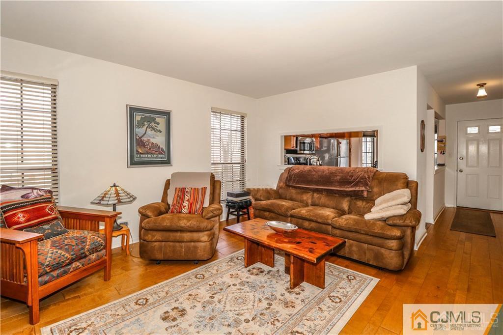 306 Maplecrest Road, Unit 306 Edison, NJ 08820 - Photo 12 of 25 a living room with furniture a rug and a window