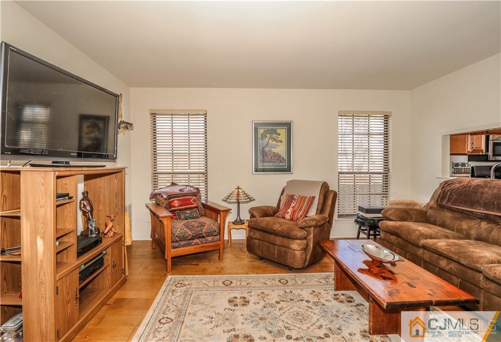 306 Maplecrest Road, Unit 306 Edison, NJ 08820 - Photo 13 of 25 a living room with furniture flat screen tv and a couch