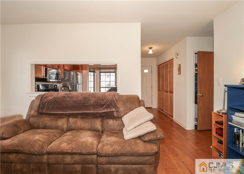 306 Maplecrest Road, Unit 306 Edison, NJ 08820 - Photo 14 of 25 a living room with a couch and a flat screen tv