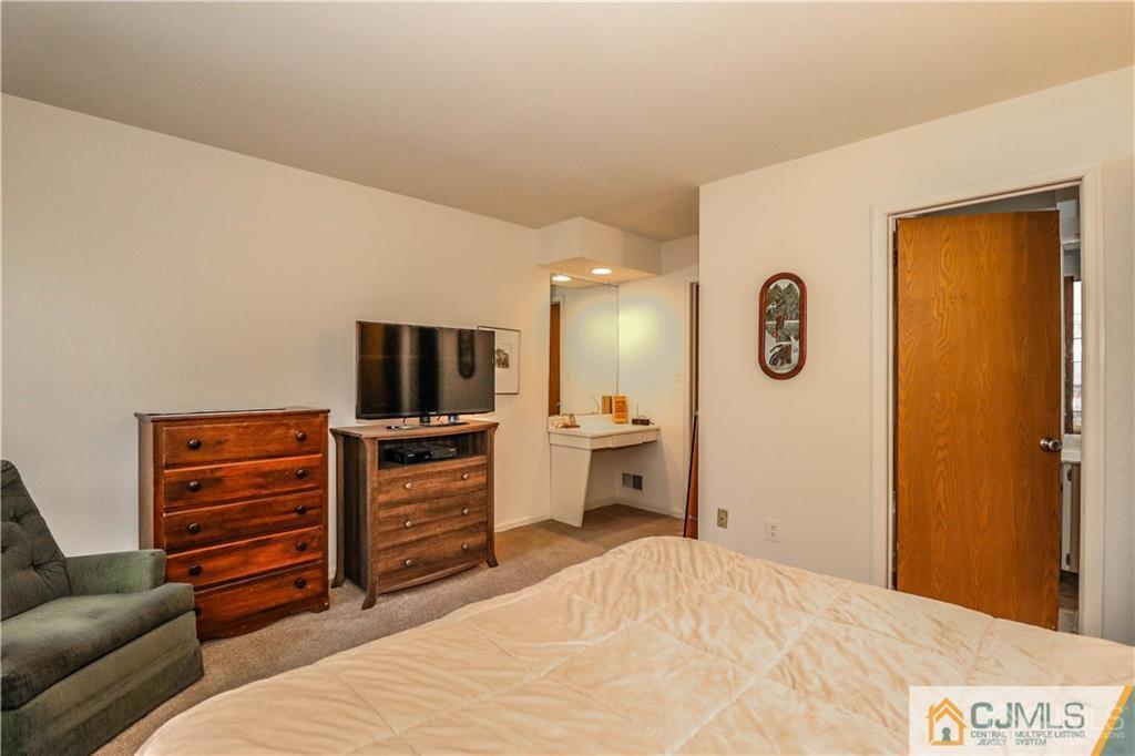 306 Maplecrest Road, Unit 306 Edison, NJ 08820 - Photo 16 of 25 a bedroom with a bed and furniture