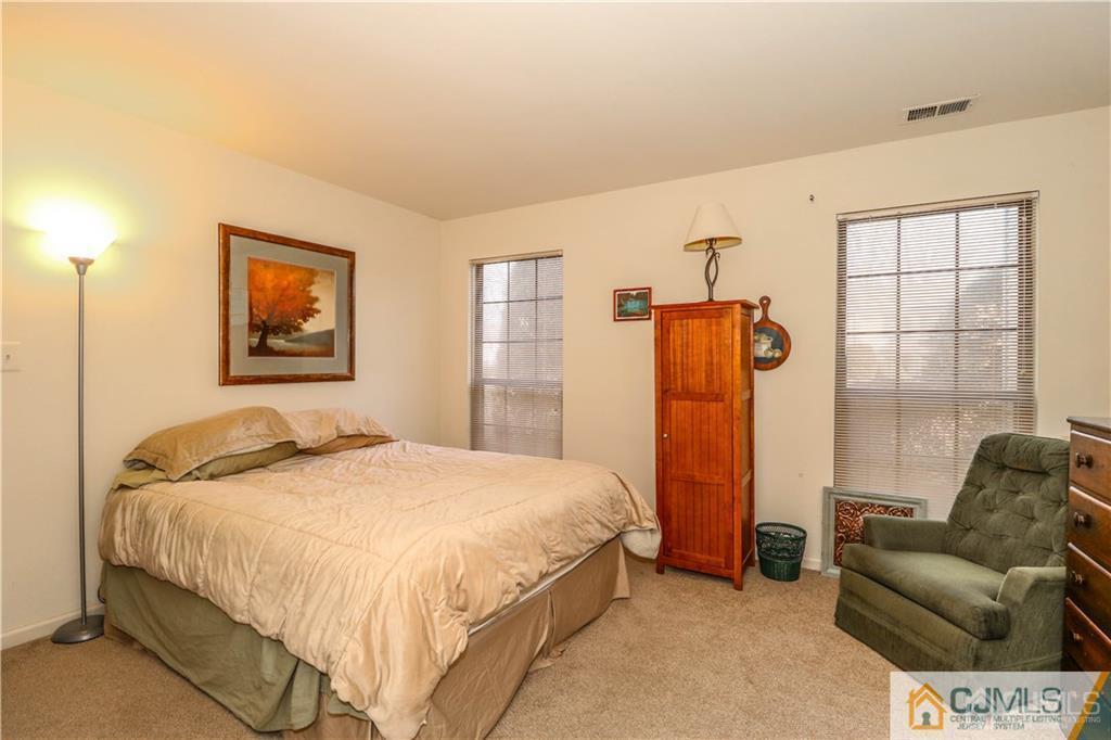 306 Maplecrest Road, Unit 306 Edison, NJ 08820 - Photo 17 of 25 a bedroom with a bed and a couch