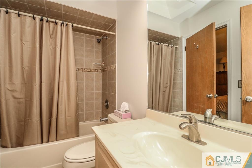 306 Maplecrest Road, Unit 306 Edison, NJ 08820 - Photo 20 of 25 a bathroom with a sink a toilet and shower