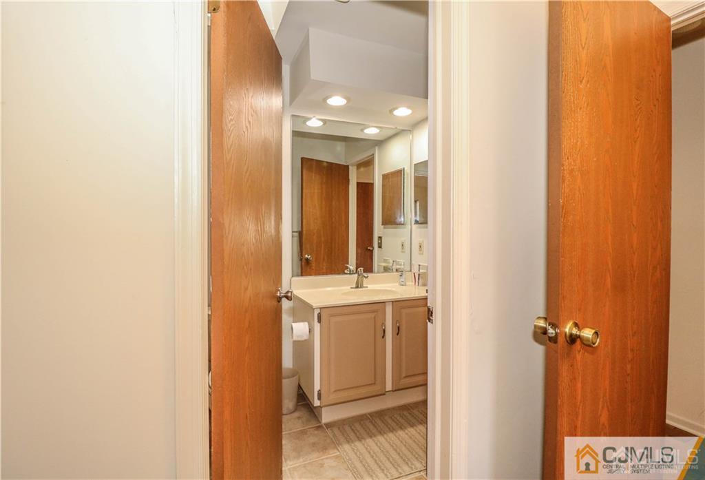 306 Maplecrest Road, Unit 306 Edison, NJ 08820 - Photo 21 of 25 a bathroom with a sink and mirror with shower