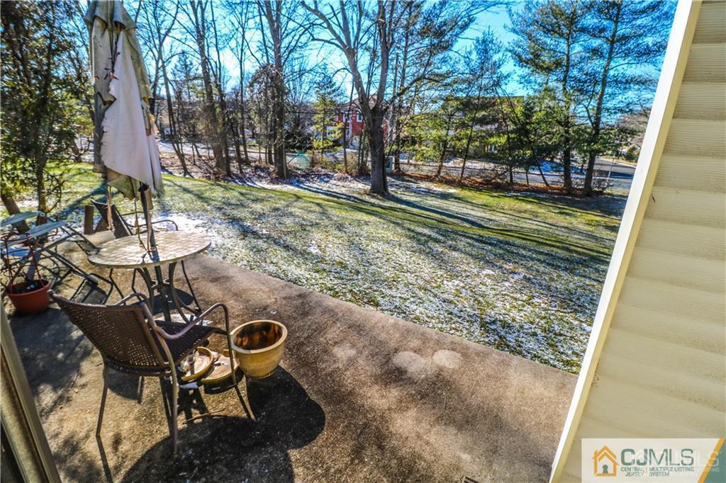 306 Maplecrest Road, Unit 306 Edison, NJ 08820 - Photo 23 of 25 a backyard of a house with table and chairs