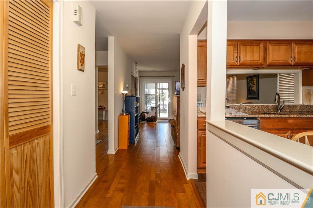 306 Maplecrest Road, Unit 306 Edison, NJ 08820 - Photo 4 of 25 a view of a hallway with wooden floor and a living room