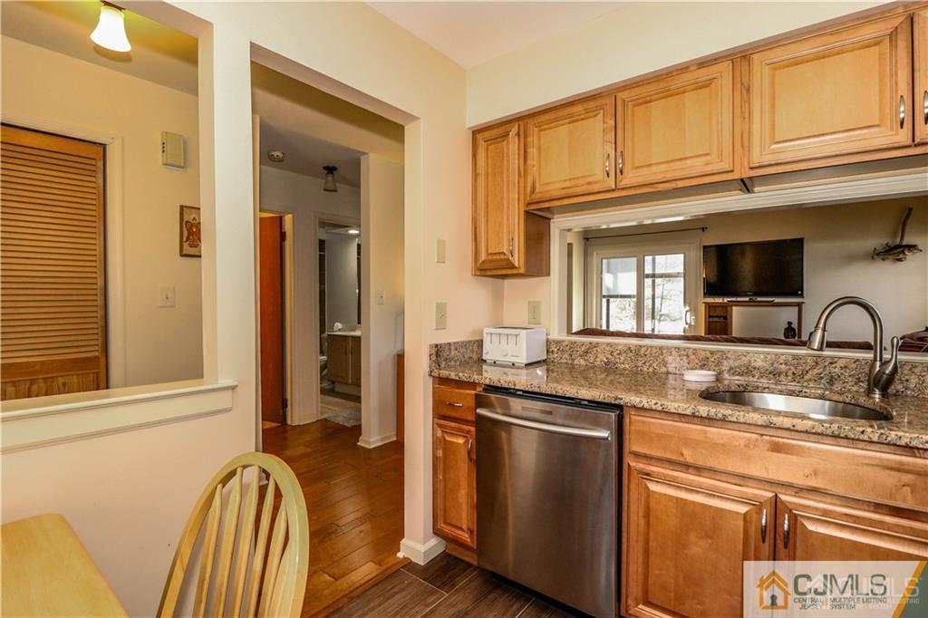 306 Maplecrest Road, Unit 306 Edison, NJ 08820 - Photo 9 of 25 a kitchen with stainless steel appliances granite countertop a sink and a stove with granite countertops