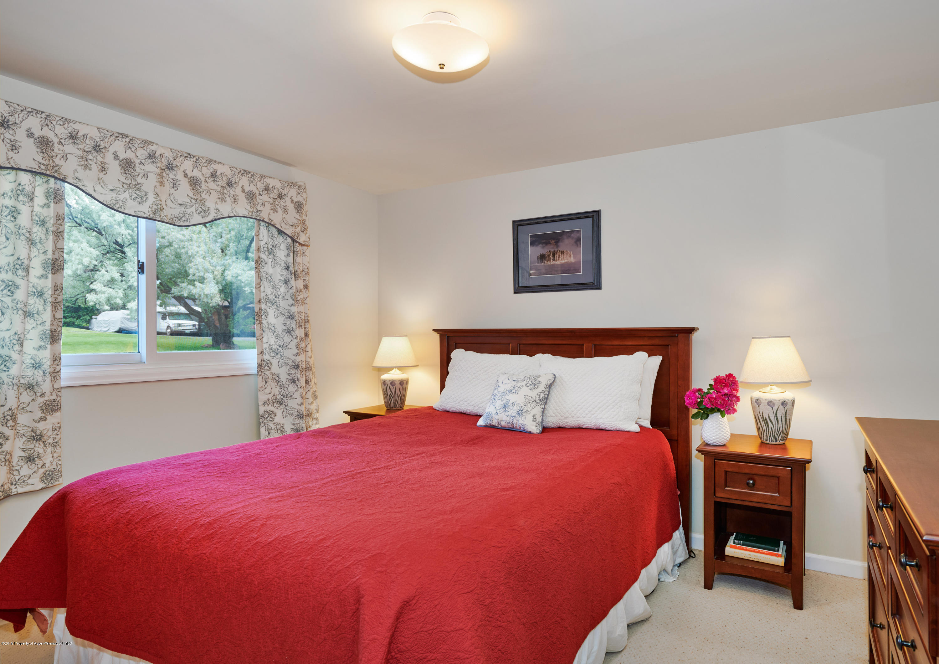 269 Holland Hills Road Basalt, CO 81621 - Photo 10 of 23 a bed sitting in a bedroom next to a window