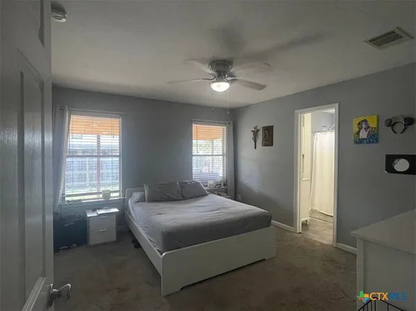 a bedroom with a bed and window