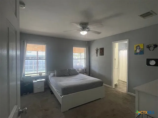 a bedroom with a bed and window