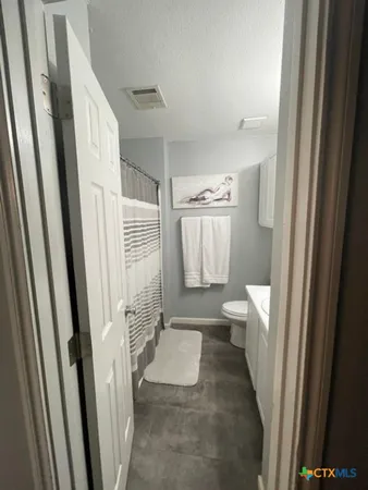 a bathroom with a sink a toilet and a shower
