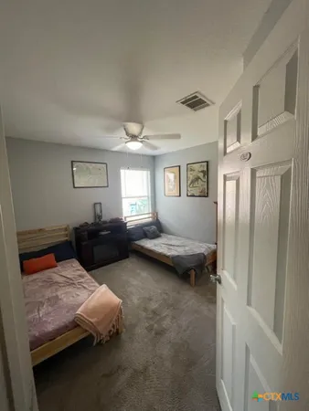 a bedroom with furniture and a window